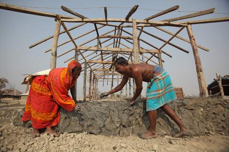 People install stone to a new home in Bangladesh