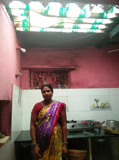 A person wearing a sari stands under an Airlite roof.