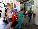 People rush from an ambulance into a hopsital.