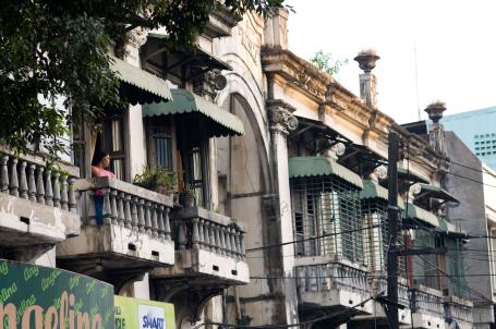 A woman stands on a balcony in Iloilo City, Philippines. 