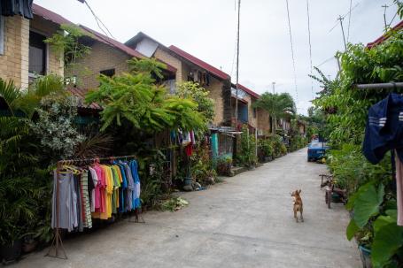 A street lies between a row of stone houses in Iloilo City, Philippines.