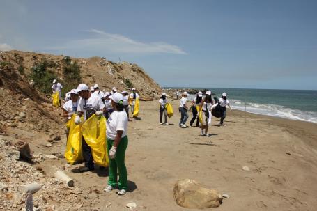 Volunteers pick up trash at a beach in Venezuela.